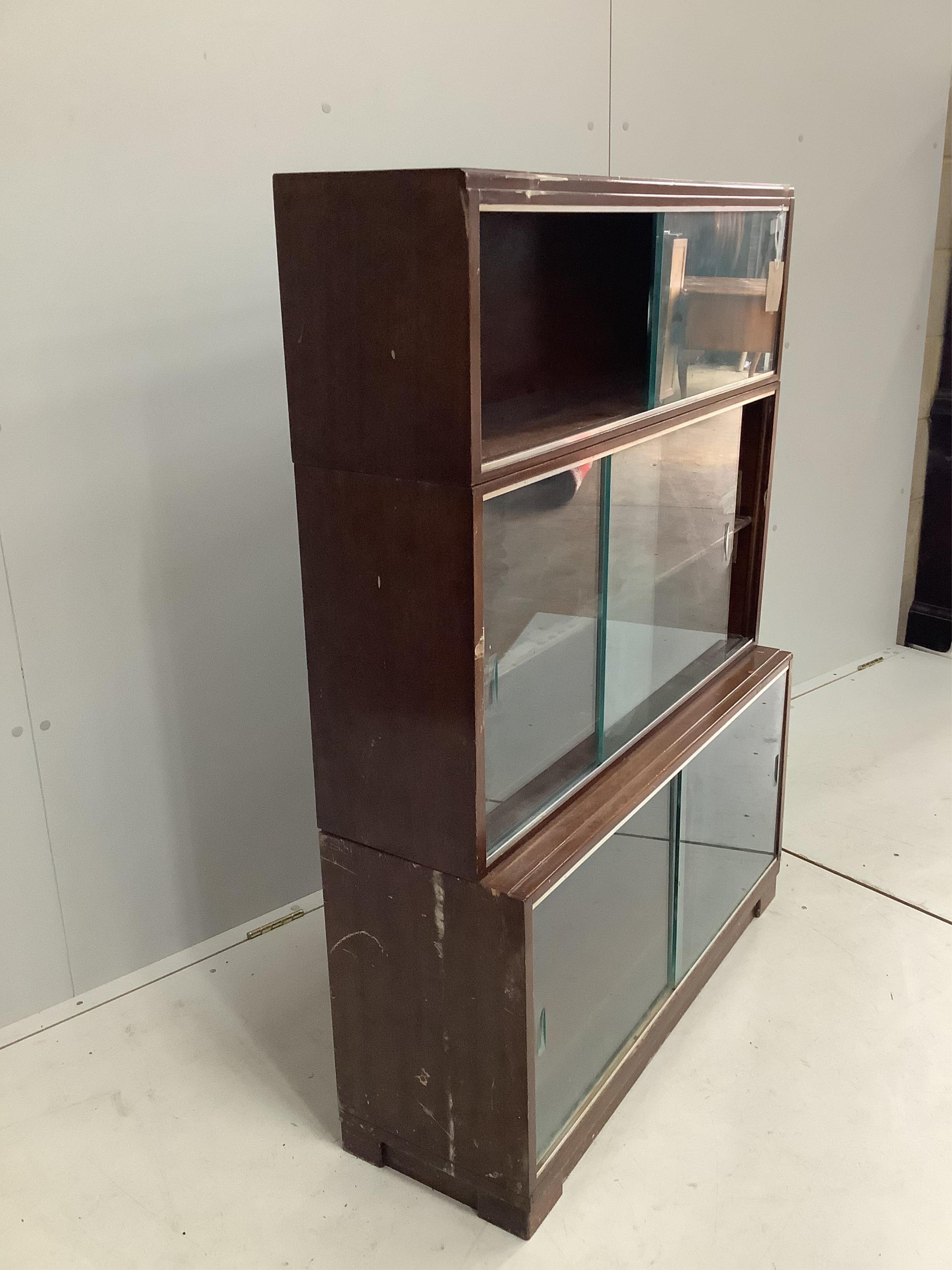 A mid century three section Minty bookcase, width 90cm, height 131cm. Condition - poor